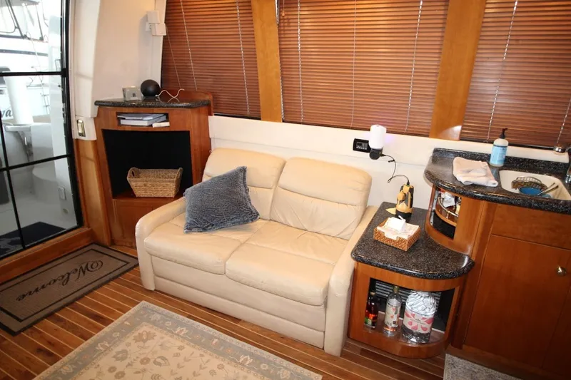 Slide: The Image of Interior of 2000 Carver 530 Voyager Pilothouse with beige sofa and wooden accents. - 20