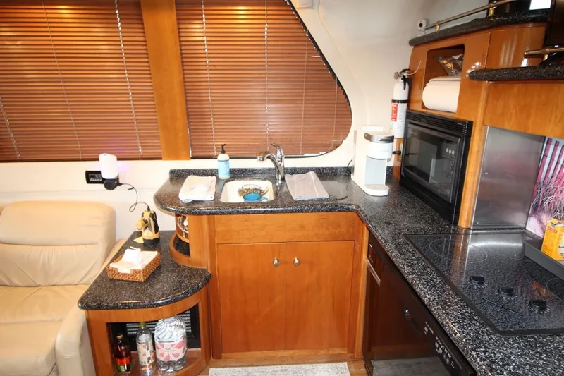 Slide: The Image of Luxurious kitchen interior of 2000 Carver 530 Voyager Pilothouse yacht with modern amenities. - 22