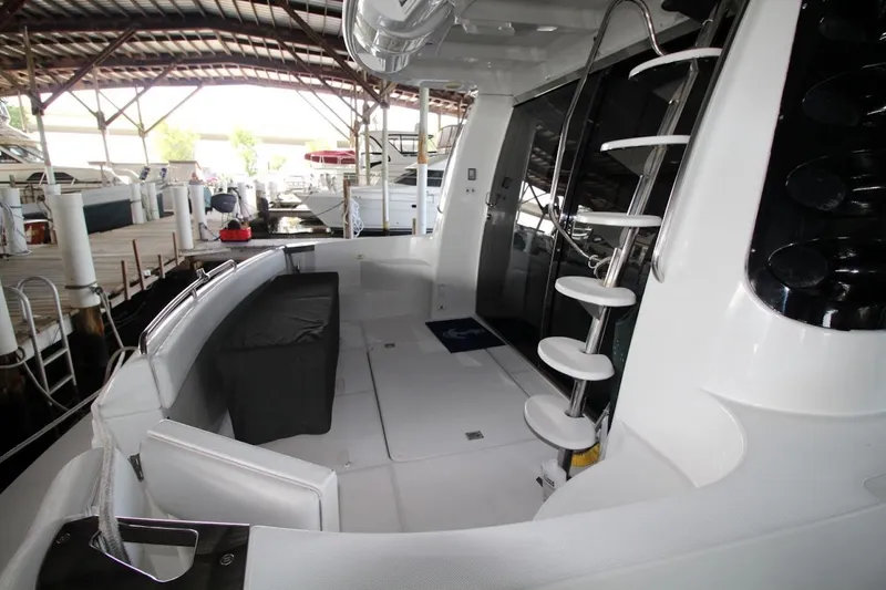 Slide: The Image of 2000 Carver 530 Voyager Pilothouse yacht interior with spiral staircase and dock view. - 8
