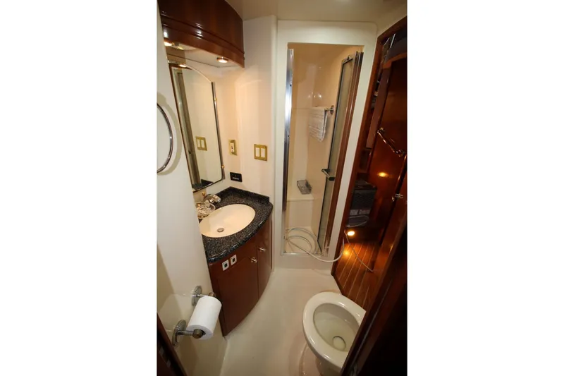 Slide: The Image of Bathroom interior of 2000 Carver 530 Voyager Pilothouse yacht, featuring sink, shower, and toilet. - 27