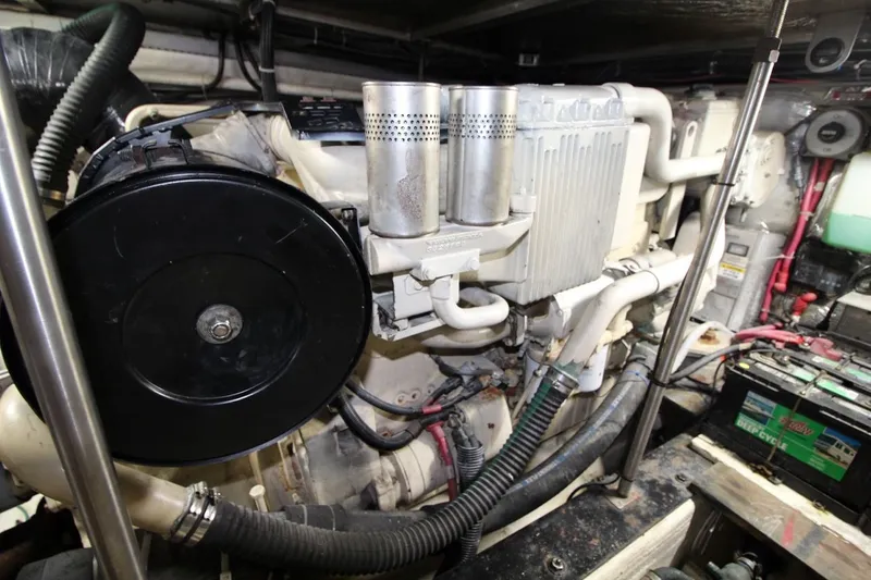 Slide: The Image of Engine room of a 2000 Carver 530 Voyager Pilothouse, showcasing mechanical components and battery. - 41