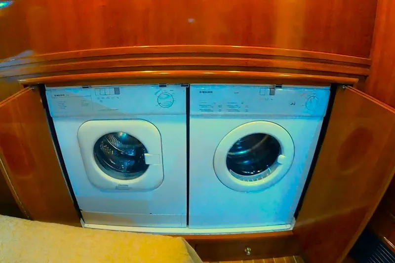Slide: The Image of Laundry appliances inside a 2000 Carver 530 Voyager Pilothouse yacht's wooden interior. - 31