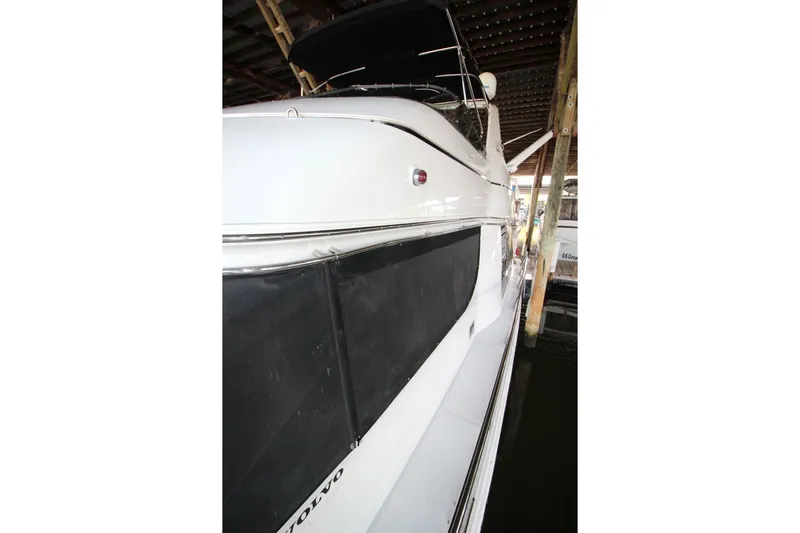 Slide: The Image of 2000 Carver 530 Voyager Pilothouse yacht docked in a covered marina. - 11