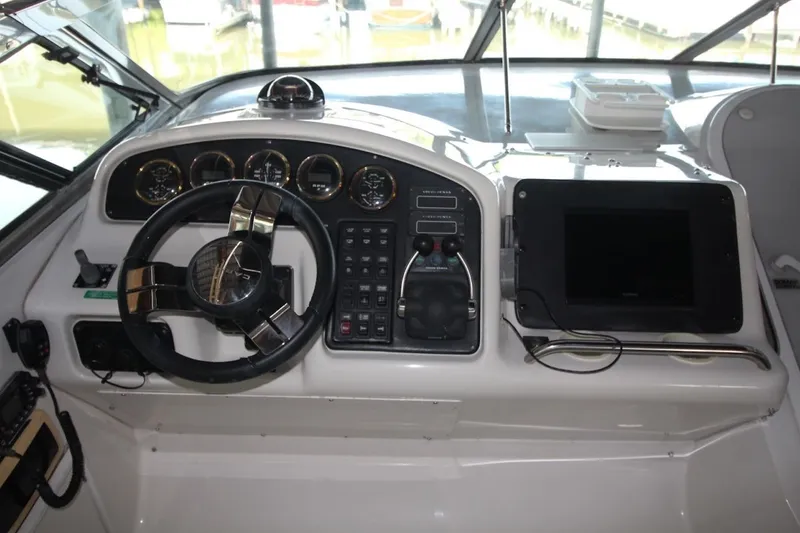 Slide: The Image of Cockpit of 2000 Carver 530 Voyager Pilothouse with steering wheel and control panel. - 17