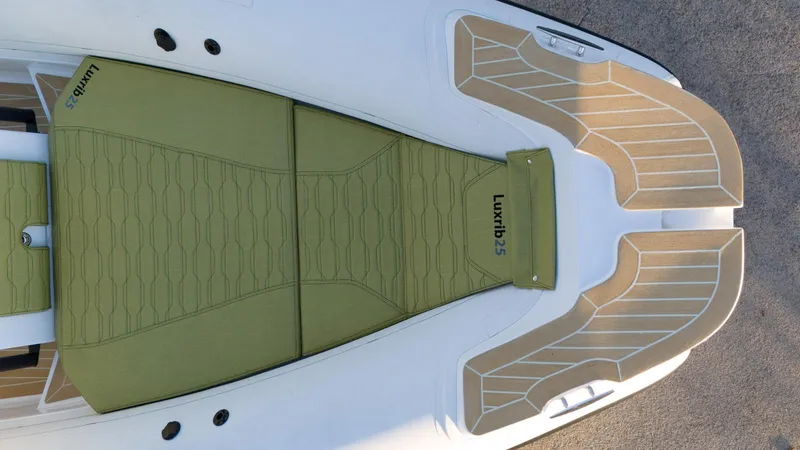 Slide: The Image of Aqvaboats Luxrib 25, 2025 model, featuring green seating and sleek deck design. - 9