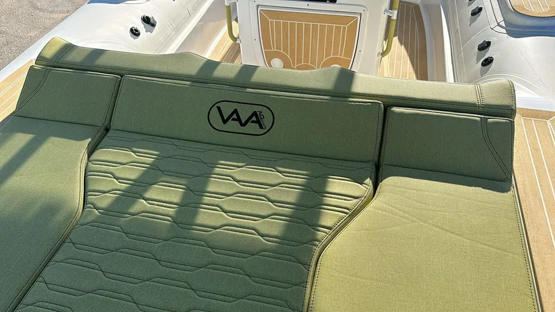 Slide: The Image of 2025 Aqvaboats Luxrib 25 with green cushioned seating and wood-style flooring. - 20