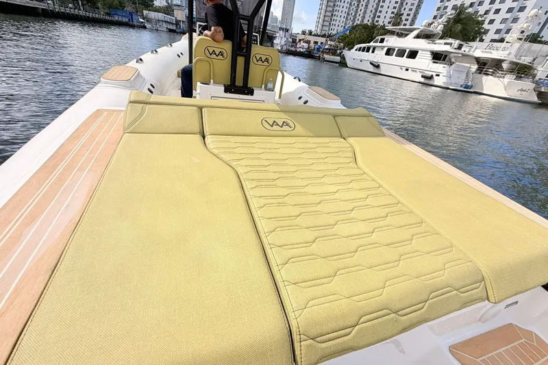 Slide: The Image of Luxurious Aqvaboats Luxrib 25, 2027 model, with spacious deck and elegant seating on a scenic waterway. - 19