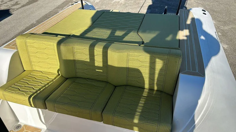 Slide: The Image of Aqvaboats Luxrib 25 (2025) with green cushioned seating on deck. - 22