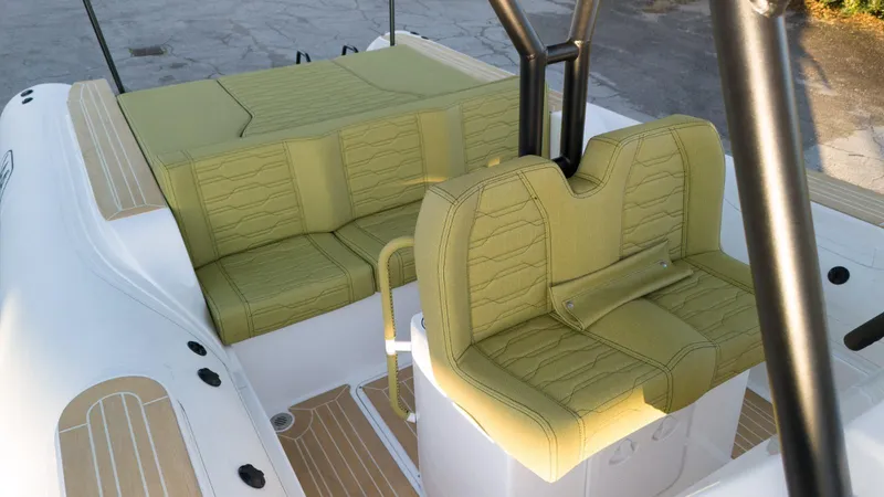 Slide: The Image of Aqvaboats Luxrib 25, 2025 model, featuring luxurious green seating and sleek design. - 26