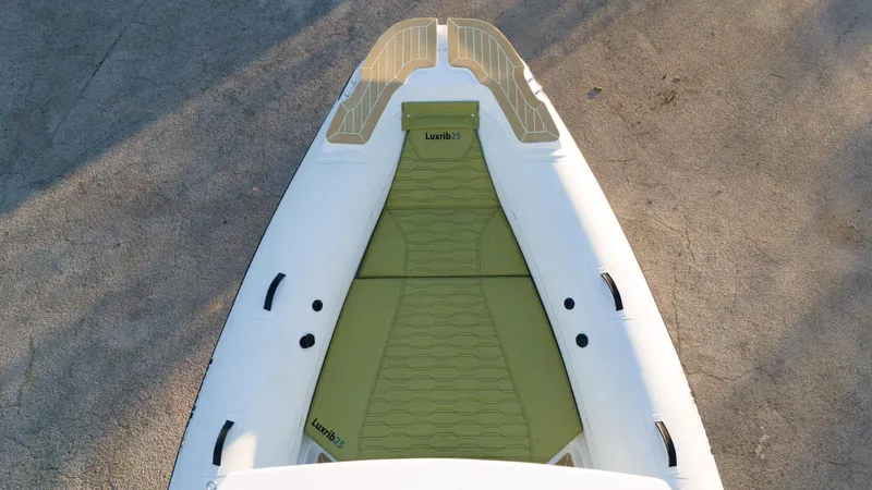 Slide: The Image of Aqvaboats Luxrib 25, 2025 model, featuring a sleek white and green deck design. - 10