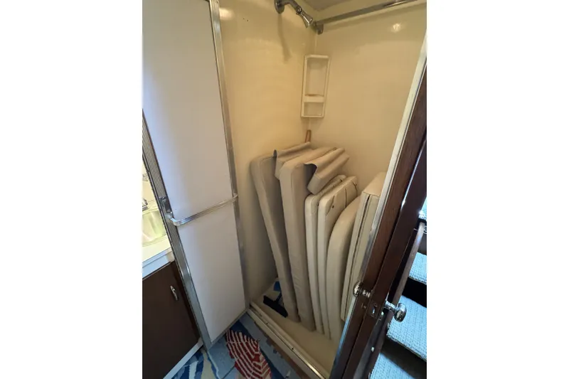 Slide: The Image of Storage area with cushions inside a 1967 Hatteras 43 Motor Yacht. - 30