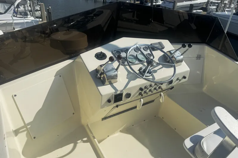 Slide: The Image of 1967 Hatteras 43 Motor Yacht helm with steering wheel and control panel. - 7
