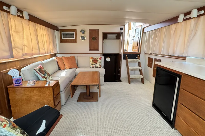 Slide: The Image of Interior of 1967 Hatteras 43 Motor Yacht with cozy seating and wooden accents. - 20