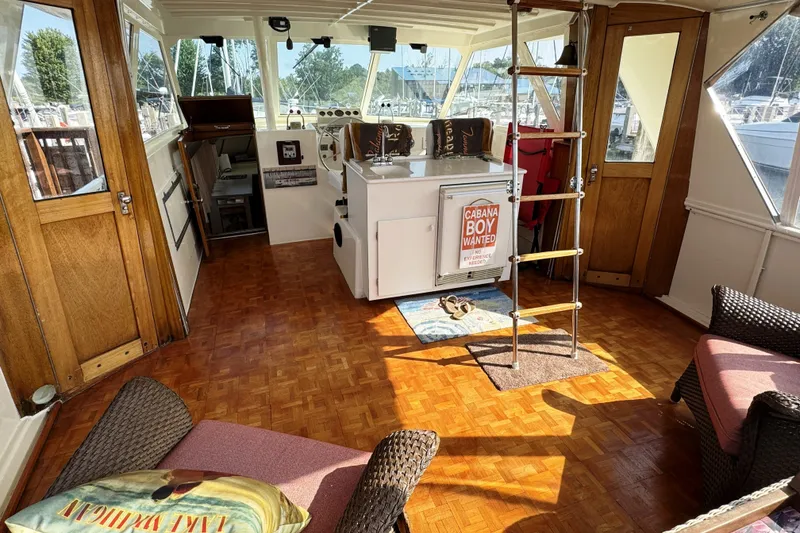 Slide: The Image of Interior of a 1967 Hatteras 43 Motor Yacht with wooden flooring and nautical decor. - 12