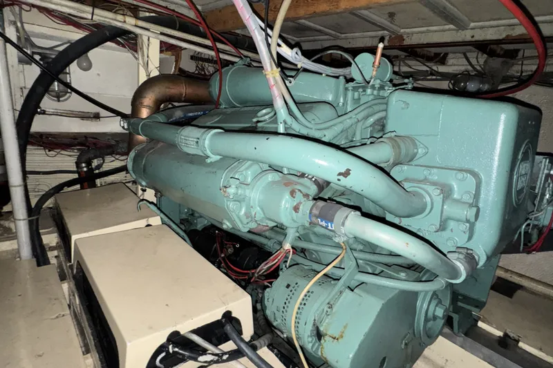 Slide: The Image of Engine room of a 1967 Hatteras 43 Motor Yacht with visible machinery and wiring. - 32
