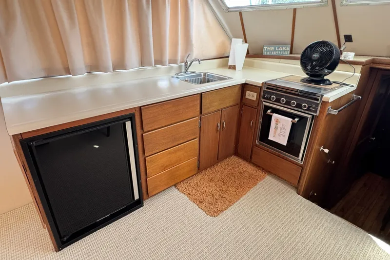 Slide: The Image of Interior of 1967 Hatteras 43 Motor Yacht kitchen with sink, stove, and mini-fridge. - 22