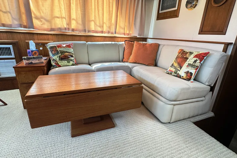 Slide: The Image of Interior of 1967 Hatteras 43 Motor Yacht with cozy seating and wooden table. - 21