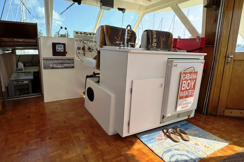 Slide: The Image of 1967 Hatteras 43 Motor Yacht interior with helm, decor, and humorous sign. - 13