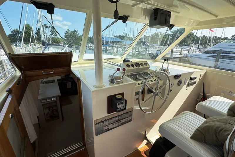 Slide: The Image of Interior view of a 1967 Hatteras 43 Motor Yacht helm with classic controls and seating. - 16