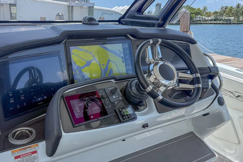 Slide: The Image of Helm of 2020 MTI V42 boat with navigation screens and steering wheel. - 7