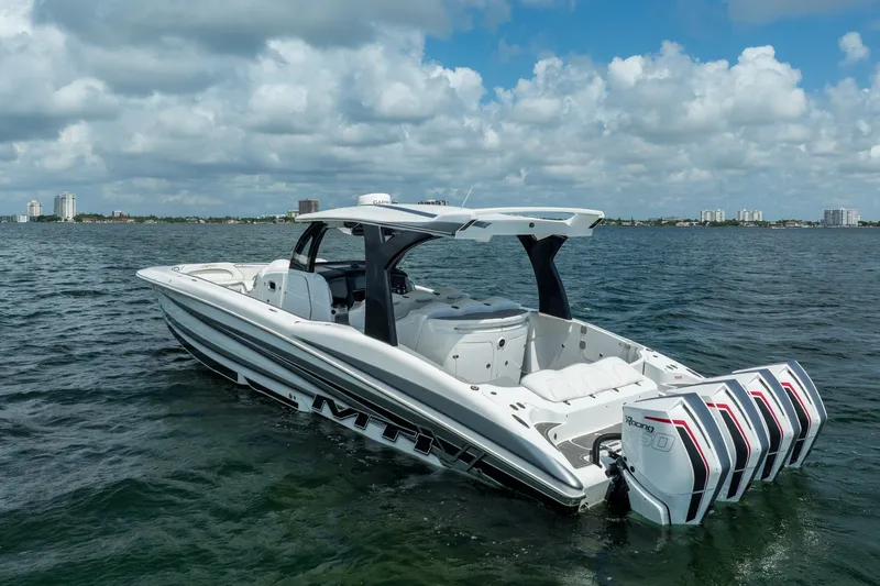 Slide: The Image of 2020 MTI V42 boat with quad engines on open water under cloudy sky. - 4