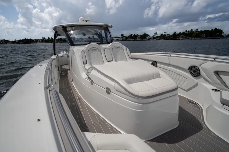 Slide: The Image of Luxury MTI V42 boat interior with plush seating, cruising on a calm waterway. - 15