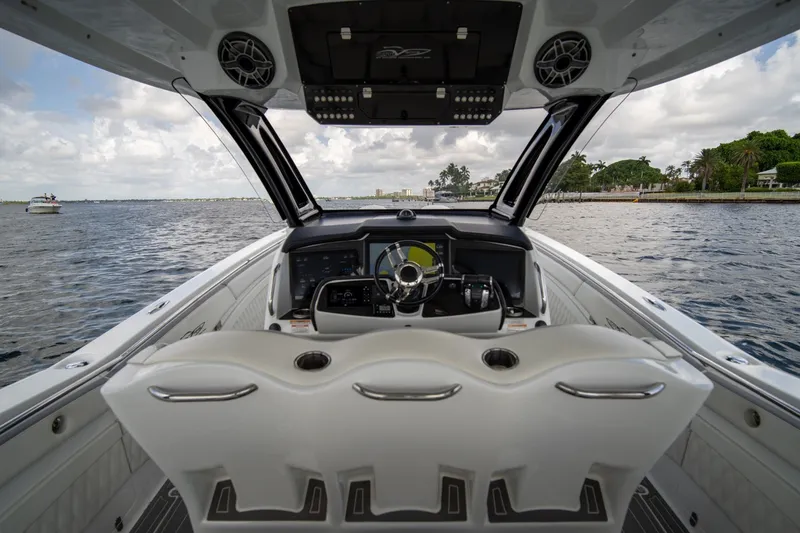 Slide: The Image of Cockpit view of 2020 MTI V42 boat on water, featuring modern steering and controls. - 6