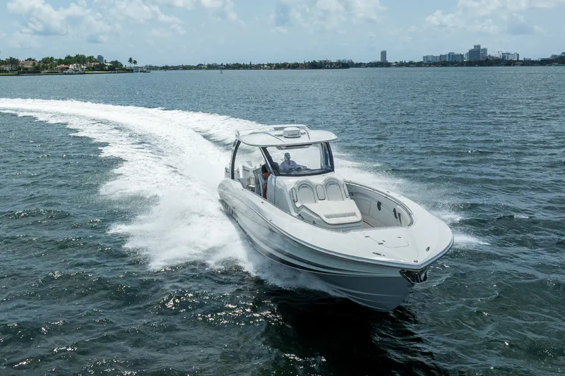 Slide: The Image of MTI V42 2020 model speedboat cruising on open water under a clear sky. - 18
