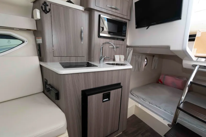 Slide: The Image of 2020 Regal 2860 Window Express cabin interior with kitchenette, bed, and modern amenities. - 13