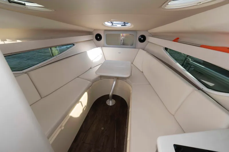 Slide: The Image of 2020 Regal 2860 Window Express cabin interior with beige seating and table. - 12