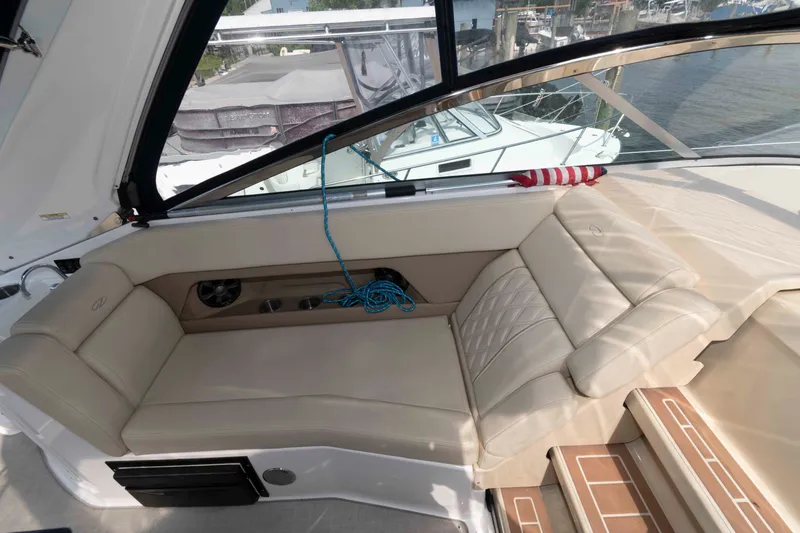 Slide: The Image of Luxurious interior of 2020 Regal 2860 Window Express boat with beige seating and waterfront view. - 10