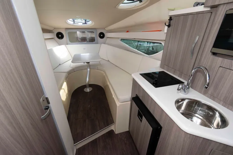 Slide: The Image of 2020 Regal 2860 Window Express cabin interior with modern kitchenette and seating area. - 11