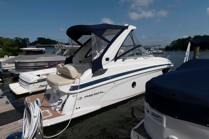 The Image of 2020 Regal 2860 Window Express boat docked at marina under clear blue sky. - 0