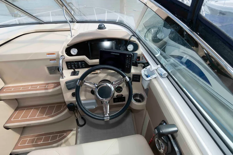 Slide: The Image of 2020 Regal 2860 Window Express boat cockpit with steering wheel and navigation controls. - 9