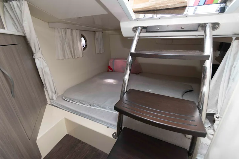 Slide: The Image of 2020 Regal 2860 Window Express cabin interior with bed and ladder. - 14