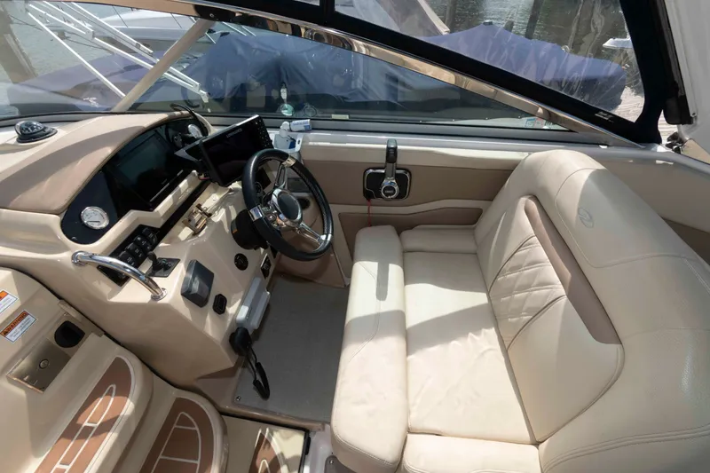 Slide: The Image of 2020 Regal 2860 Window Express boat interior with beige seating and modern dashboard. - 7