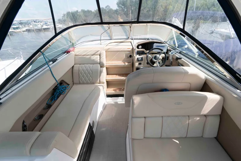 Slide: The Image of 2020 Regal 2860 Window Express boat interior with beige seating and steering console. - 5