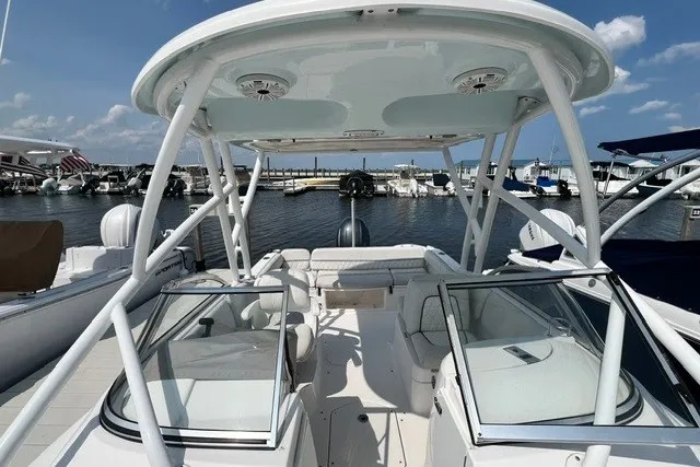 Slide: The Image of 2020 Sea Fox 226 Traveler boat docked at marina, featuring spacious seating and dual consoles. - 8