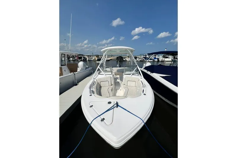 Slide: The Image of 2020 Sea Fox 226 Traveler boat docked at marina under clear blue sky. - 2