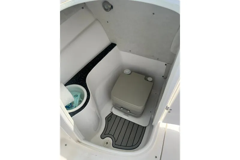 Slide: The Image of 2020 Sea Fox 226 Traveler boat interior with compact marine toilet and storage space. - 11