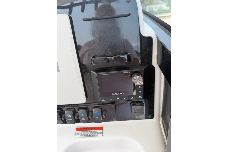 Slide: The Image of 2024 Sea Hunt Ultra 275 SE dashboard featuring JL Audio system and control panel. - 38