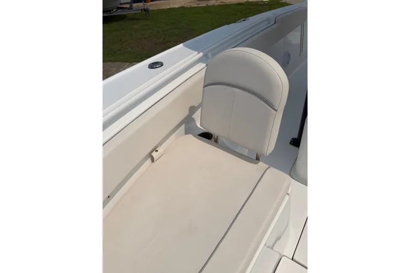 Slide: The Image of 2024 Sea Hunt Ultra 275 SE boat seat, featuring sleek white upholstery. - 29