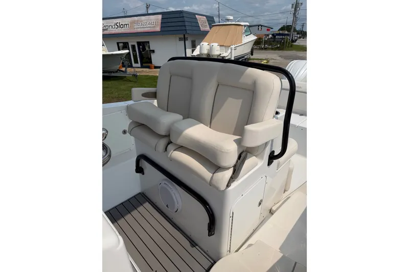 Slide: The Image of 2024 Sea Hunt Ultra 275 SE boat seat with beige upholstery and black armrests. - 41