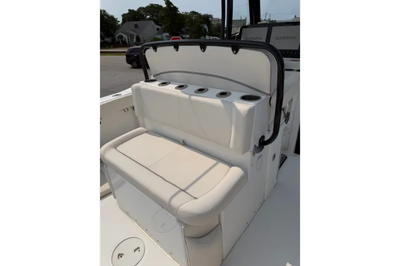 Slide: The Image of 2024 Sea Hunt Ultra 275 SE boat seating with cup holders and Garmin displays. - 45