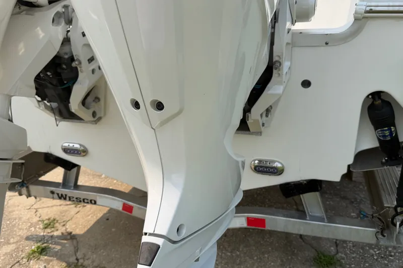 Slide: The Image of 2024 Sea Hunt Ultra 275 SE boat engine and trailer detail. - 17