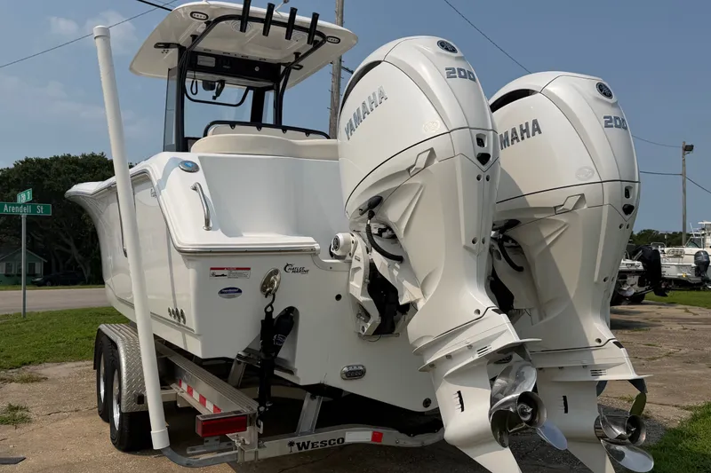 Slide: The Image of 2024 Sea Hunt Ultra 275 SE boat with dual Yamaha 200 engines on a trailer. - 6