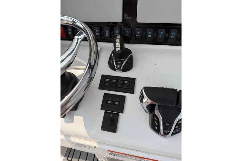 Slide: The Image of 2024 Sea Hunt Ultra 275 SE boat controls and steering wheel close-up. - 40