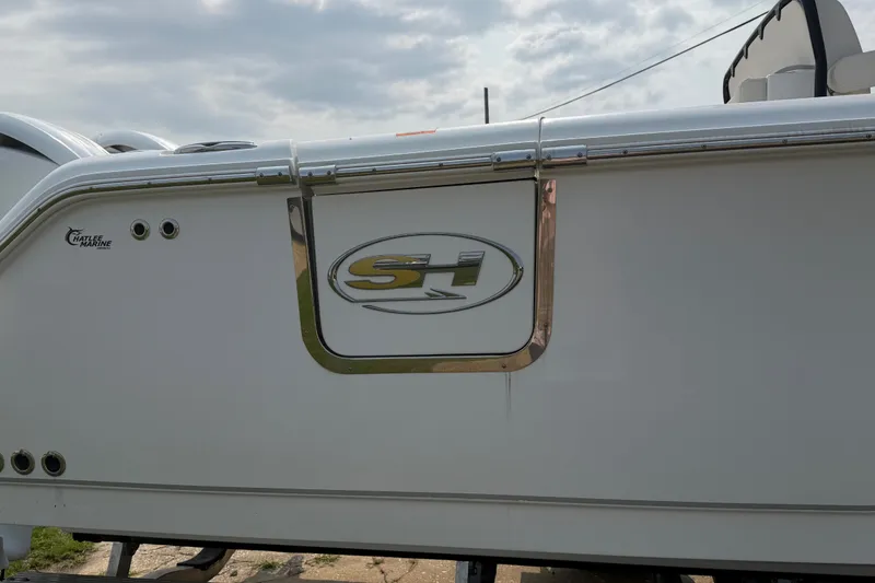 Slide: The Image of 2024 Sea Hunt Ultra 275 SE boat side view with logo and marine branding. - 11