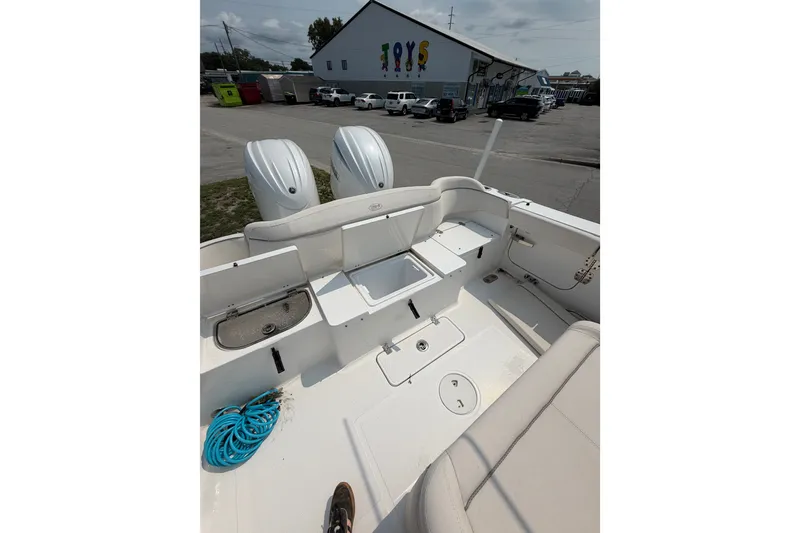 Slide: The Image of 2024 Sea Hunt Ultra 275 SE boat interior with dual engines and seating area. - 48