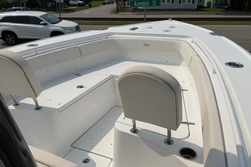 Slide: The Image of 2024 Sea Hunt Ultra 275 SE boat interior with seating and cup holders. - 22